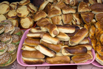 sausage in the dough on the plate with greens burgers and Shanga .