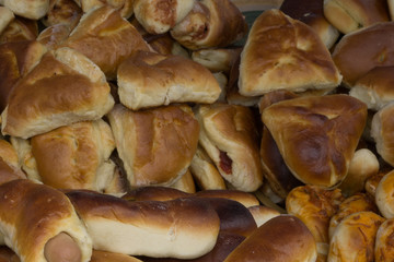 Image of a lot of sweet croissants in supermarket bakery .