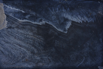 the deep texture of the scars and scratches of dirty pool .