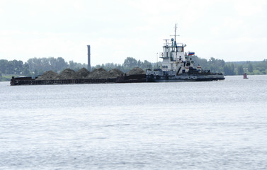 Russian barge with sand on the river to cope