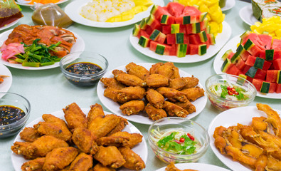 Food Variety Table top Fried chicken Fried fish roasted pork papaya salad roasted duck and fruit Orange watermelon