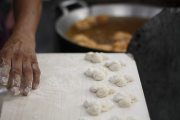 man preparing dough at street food stall
