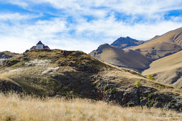 White house with purple roof standing near the mountain