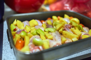 Tray with chicken drum sticks and veggies