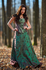 Fototapeta premium Portrait of a woman in green dress outdoor