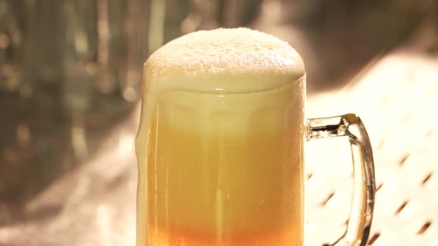 Cutting beer foam, close up. Beer foam motion and cutting.