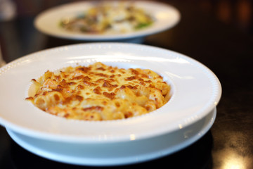 Baked Macaroni and cheese with shrimp dish. Italian food style.