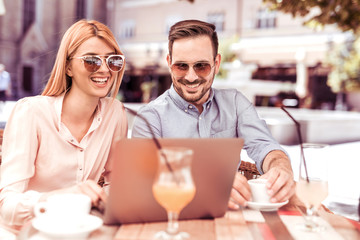 Couple using tablet computer in coffee shop.