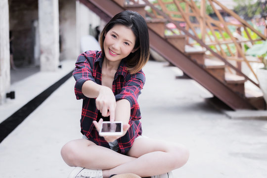 beautiful asian girl travel concept with backpack  hand hold smartphone and casual costume with happiness smile