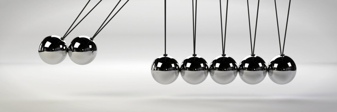 cause and effect concept, metal Newton's cradle with two balls in motion on a white background