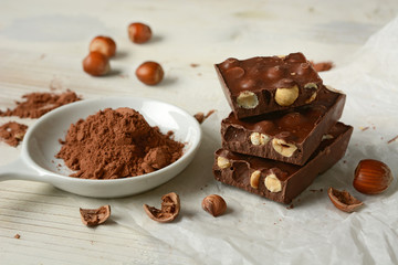 chocolate bar with hazelnuts on white table