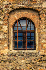 Detail of a medieval window of an old castle in Tuscany