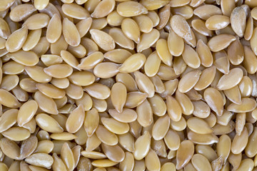 Golden flax seeds background.