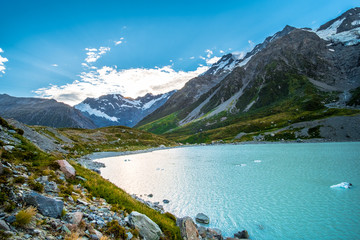 Beautiful nature in Mt Cook National Park, Green grass, Mountain, lake and snow before sunset.