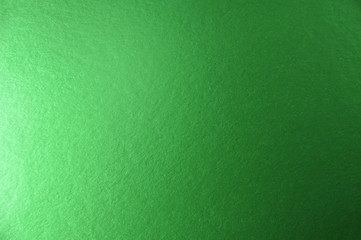 Texture of green metallic paper background for design Christmas or New Year's party cards