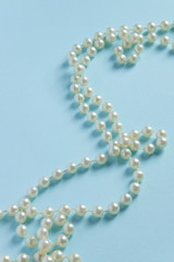 White pearls on blue background - luxury fashion concept © 682A_IA