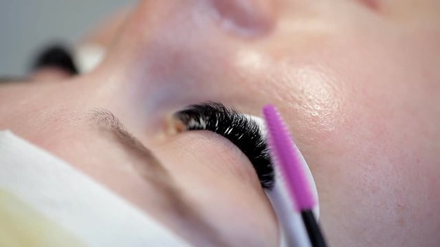 Combing the lashes after eyelash extensions
