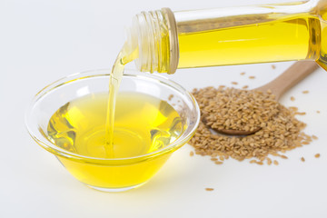 Pouring linseed oil into a glass bowl.