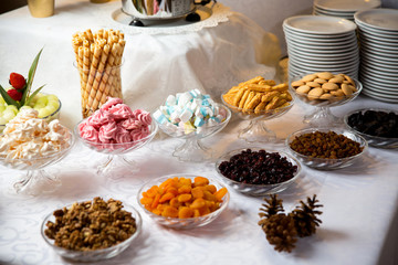 Kompozycja na stole z kolorowymi ciasteczkami i różnymi słodyczami przygotowanymi dla gości - obrazy, fototapety, plakaty