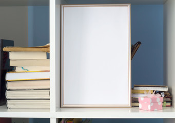 Blank photo frame on bookshelf