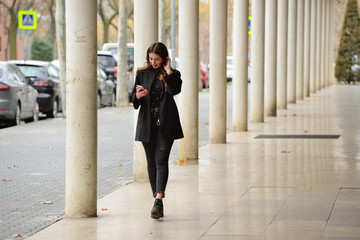 Young woman communicating by mobile.