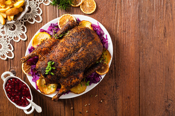 Baked whole duck, served with apples, red cabbage, oranges and roasted fritters.