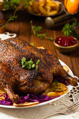 Baked whole duck, served with apples, red cabbage, oranges and roasted fritters.