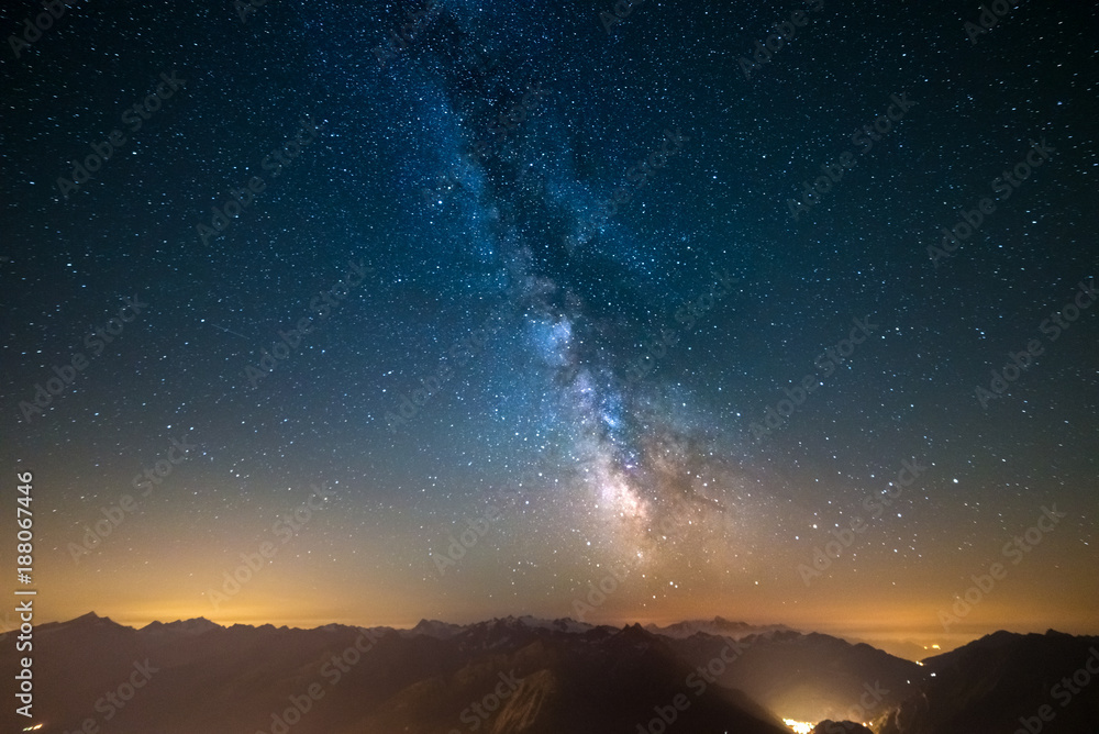 Wall mural milky way and starry sky captured at high altitude in summertime on the alps with glowing aosta vall