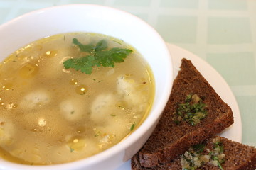 homemade chicken broth with herbs and rye croutons