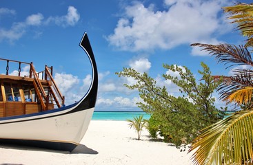 Beautiful Maldives Beach With A Dhoni traditional boat, Lonubo atoll.
