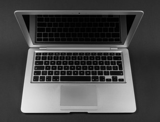 Fototapeta na wymiar Modern laptop computer on dark background.