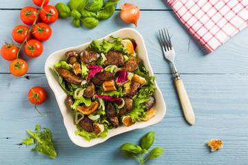 Warm salad with grilled chicken liver and toast