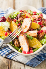 Spring salad with chicken, pomegranate, orange, pecan nuts and honey.