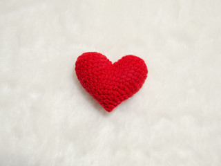 handmade red yarn heart on white wool. the red heart on the center of picture and background copy space for text. Valentines day, love concept and love background