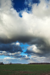 Fototapeta na wymiar Dark clouds over land.