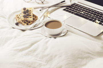 Server with breakfast and laptop on bed