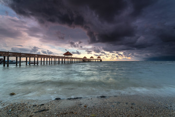Long exposure Cloudy sunrise shot at jetty. Image contain certain grain or noise and soft focus...