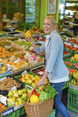 woman at the fruit market with shopping basket