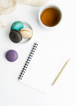 Top view flat lay Blank notebook mockup with macarons and tea cup. Art, writing concept. Text space
