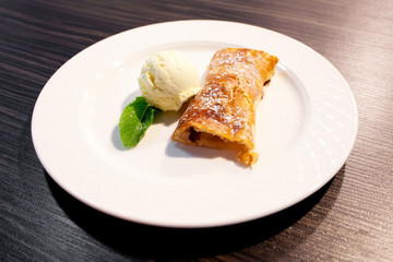 Apple strudel and ice cream on the plate