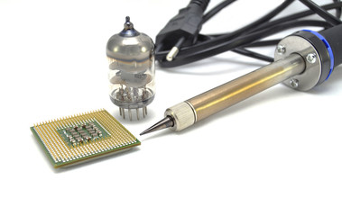 Processor and soldering iron on a white background close up