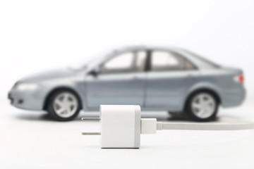 electric car with plug and wire on white background