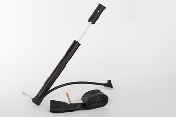 Bike inner tire tube and hand pump,  studio photo, isolated on white background