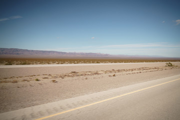 highway through Nevada desert in sunny autumn day