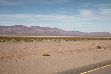 highway through Nevada desert in sunny autumn day