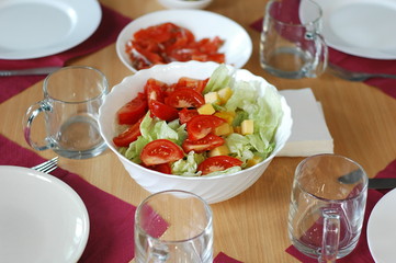 The process of preparing a festive dinner: dishes, serving, sandwiches, salads.