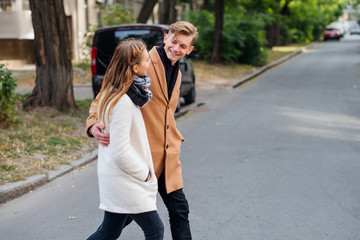 Couple walking in the street together hugging. Casual date youth lovers leisure and pastime
