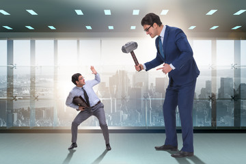 Bad angry boss threatening employee with hammer