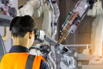 Industry 4.0 Robot concept .Engineers are using virtual AR to maintain and check the work of human robot in the 4.0 Smart Factory.