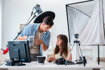 Young photographer working in photo studio